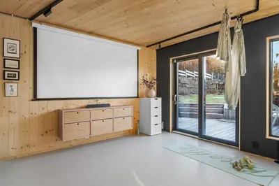 a living room with a large screen on the wall at Stay in The Hollywood Hills of Bergen with Breathtaking Views in Bergen