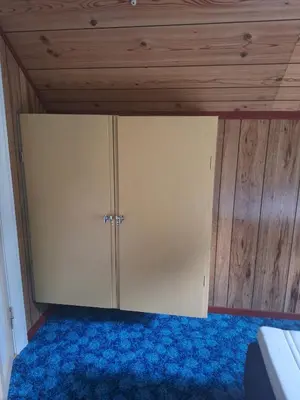 a room with a closet with a blue carpet at Villa ved sjøen og fjellene in Myklebostad