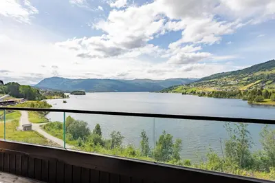 a view of a lake from a balcony at Top-Floor Lakefront Apartment near Ski Resort in Hafslo