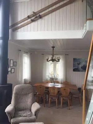 a dining room with a table and chairs at Ski in & out hytte på Lemonsjøen i Jotunheimen in Randsverk
