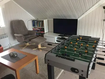 a living room with a pool table and a tv at Ski in & out hytte på Lemonsjøen i Jotunheimen in Randsverk