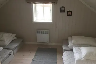 a living room with two beds and a window at Ski in & out hytte på Lemonsjøen i Jotunheimen in Randsverk