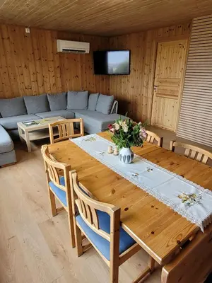 a living room with a wooden table and a couch at Adventure house Katrine in Mosvik