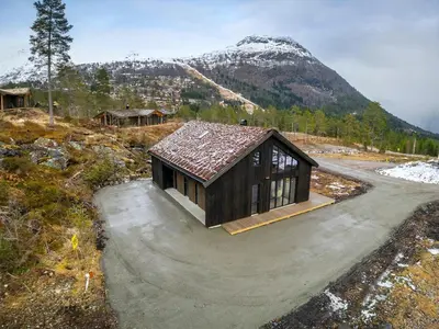 a small house in the middle of a mountain at Hydla Mountain Lodge in Stryn