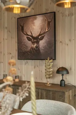 a painting of a deer hanging on a wall at Hydla Mountain Lodge in Stryn