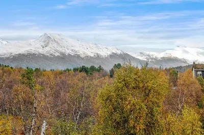 a view of a mountain range with snow covered mountains at Idyllic Apartment at Strandafjellet in Stranda