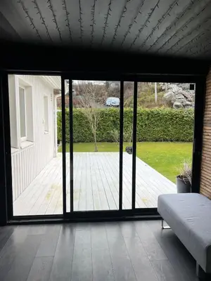 a bedroom with a large sliding glass door to a deck at Bergen - Home, Close to Airport and the city in Bergen