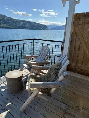 a stuffed animal sitting in a rocking chair on a deck at Stryn Fjord Cottage Faleide in Stryn