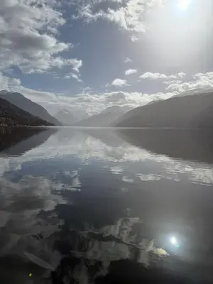 a large body of water with mountains and the sky at Stryn Fjord Cottage Faleide in Stryn