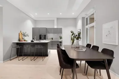 a kitchen and dining room with a table and chairs at City Centrum Villa Apartments w parking in Bergen
