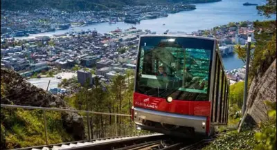 a tram on a mountain with a view of a city at City Centrum Villa Apartments w parking in Bergen
