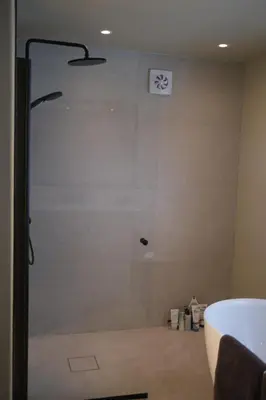 a shower with a glass door in a bathroom at Nesheim in Alnes