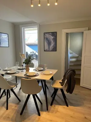 a dining room with a table and chairs at Skuteviken House in Bergen