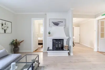 a living room with a couch and a fireplace at Skuteviken House in Bergen