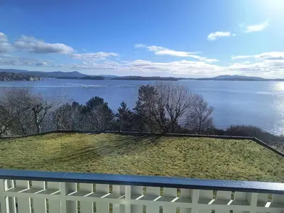 a view of a lake from a balcony at Skjærgårdsidyll in Askøy