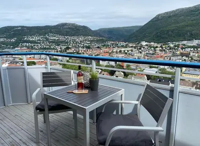 a table and chairs on a balcony with a view at 2 Bedroom Apartment with free parking lot in Bergen