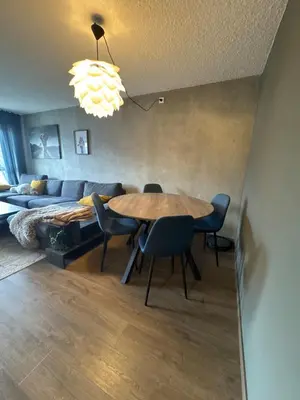 a living room with a table and a couch at 2 Bedroom Apartment with free parking lot in Bergen
