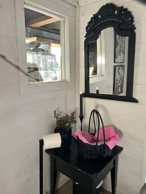 a mirror and a table with a basket on it at Støl ved Sognefjorden in Berge