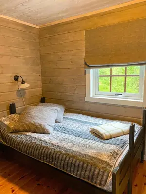 a bed in a room with a window at Perla i Nordfjord in Emhjella