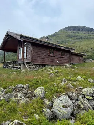 a wooden house on a hill with rocks at Wild Norwegian nature, between Preikestolen & Trolltunga in Sauda