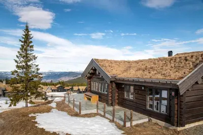 a log cabin with snow on the ground at Nordic Gateway Logde in Hafjell