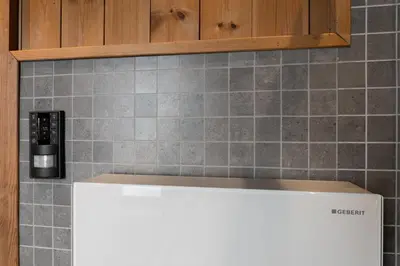 a kitchen with a white counter top and a tile wall at Nordic Gateway Logde in Hafjell