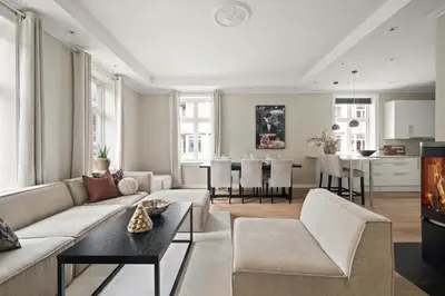 a living room with a couch and a table at Scandinavian Luxury in Bergen's Finest Street in Bergen