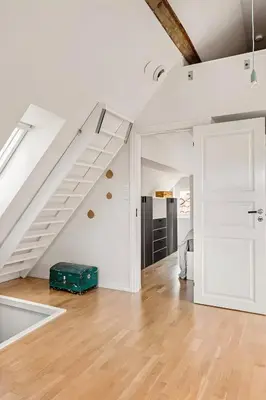 an open living room with a staircase and a suitcase at Design Apartment by Bryggen - View & Location in Bergen