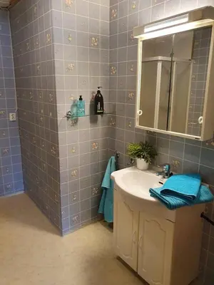 a bathroom with a sink and a mirror at Sandeidfjorden overnatting in Sandeid