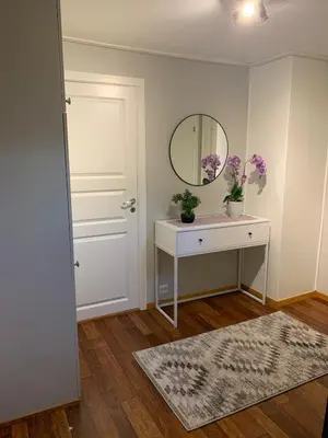 a bathroom with a sink and a mirror and a door at 4 bedroom house in beautiful Oldedalen in Stryn