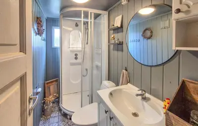 a bathroom with a sink and a toilet and a shower at Pet Friendly Home In Nedre Vats in Åmsosen