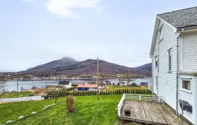 a white house with a view of a body of water at Pet Friendly Home In Nedre Vats in Åmsosen