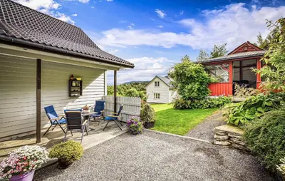 a patio with chairs and a table in a yard at Nice Home In Lundegrend With Wifi in Grimsland