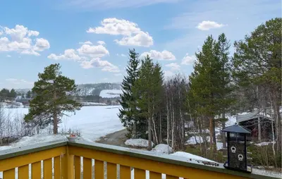a balcony with a view of a lake and snow at Beautiful Home In Bjorli With Wifi in Bjorli