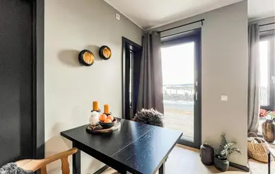 a dining room with a black table and a window at 2 Bedroom Awesome Apartment In Sjusjøen in Sjusjøen