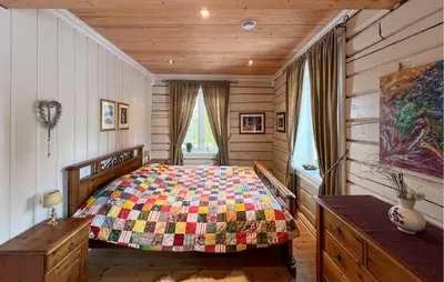 a bedroom with a bed with a colorful quilt at Nice Home In Sjusjøen With Wifi in Sjusjøen