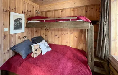 a teddy bear sitting on a bed in a cabin at Nice Home In Sjusjøen With Wifi in Sjusjøen