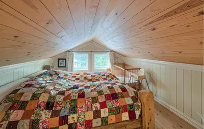a bed in a room with a wooden ceiling at Nice Home In Sjusjøen With Wifi in Sjusjøen