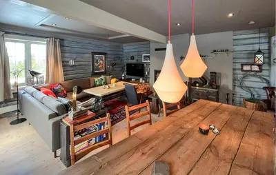 a living room with a couch and a wooden table at Nice Home In Sjusjøen With Wifi in Sjusjøen