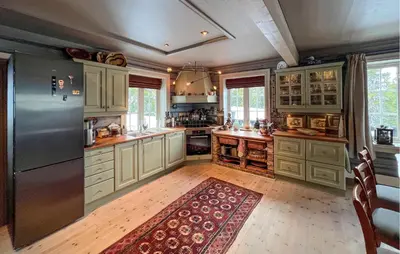a kitchen with white cabinets and a large refrigerator at Nice Home In Sjusjøen With Wifi in Sjusjøen