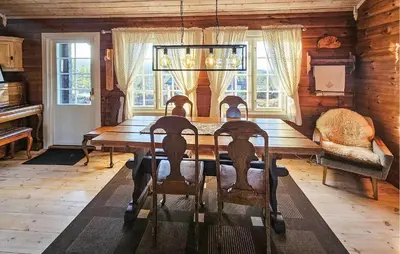 a dining room with a long wooden table and chairs at Stunning Home In Flesberg With Sauna in Flesberg