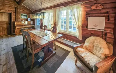 a dining room with a wooden table and a chair at Stunning Home In Flesberg With Sauna in Flesberg