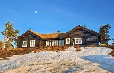 a wooden house with snow in front of it at Stunning Home In Flesberg With Sauna in Flesberg