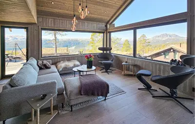 a living room with a couch and chairs and windows at Beautiful Home In Tuddal With Wifi in Tuddal