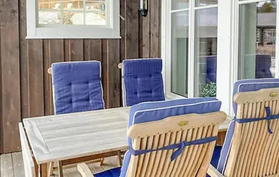 a wooden table and chairs on a porch at Gorgeous Home In Oppdal With Wifi in Oppdal