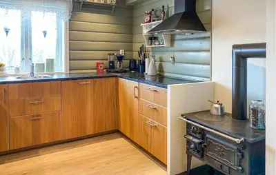 a kitchen with wooden cabinets and a stove at Gorgeous Home In Oppdal With Wifi in Oppdal