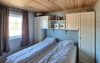 a bedroom with two beds in a room with a window at 4 Bedroom Stunning Home In Hebnes in Hebnes