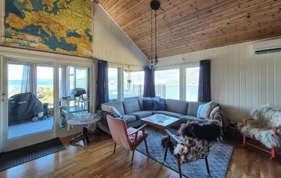 a living room with a couch and a map on the wall at 4 Bedroom Stunning Home In Hebnes in Hebnes