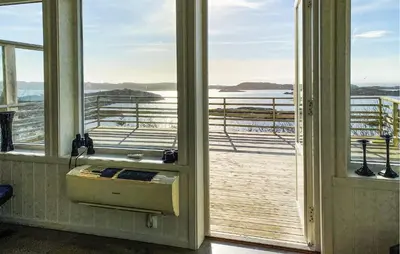 a room with a window with a view of the ocean at 5 Bedroom Beautiful Home In Kverva in Kverva