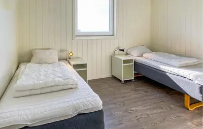a room with two beds and a window at 5 Bedroom Beautiful Home In Kverva in Kverva